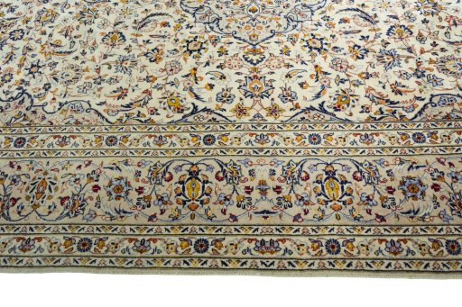Corner detail of 2000s Kashan rug showing border pattern and Wool pile