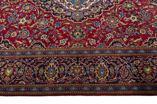 Corner detail of 2000s Kashan rug showing border pattern and Wool pile