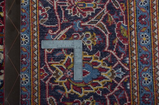 Backside of handmade 2000s Kashan rug showing knot structure and weave density