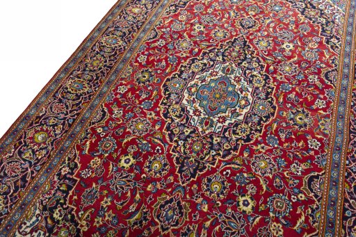 Backside of handmade 2000s Kashan rug showing knot structure and weave density