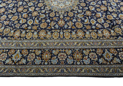Corner detail of 2000s Kashan rug showing border pattern and Wool pile