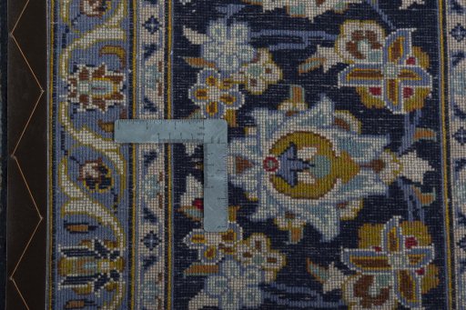 Backside of handmade 2000s Kashan rug showing knot structure and weave density