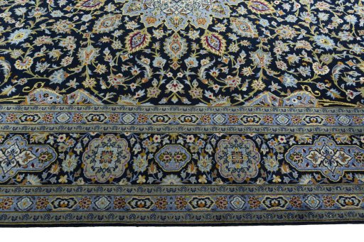 Corner detail of 2000s Kashan rug showing border pattern and Wool pile