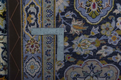 Backside of handmade 2000s Kashan rug showing knot structure and weave density