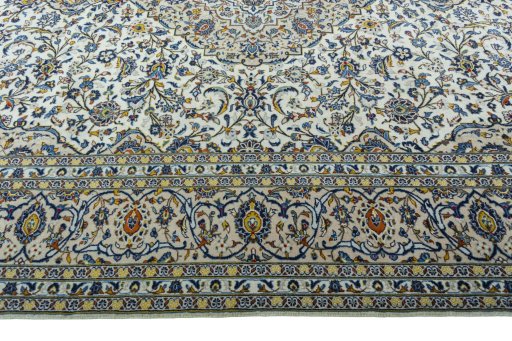 Corner detail of 2000s Kashan rug showing border pattern and Wool pile