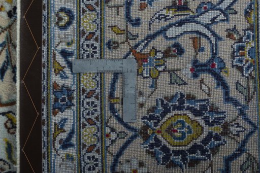 Backside of handmade 2000s Kashan rug showing knot structure and weave density