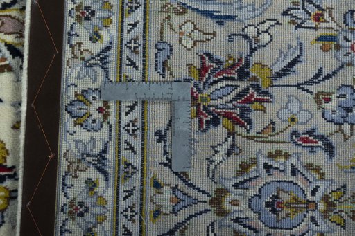 Backside of handmade 2000s Kashan rug showing knot structure and weave density