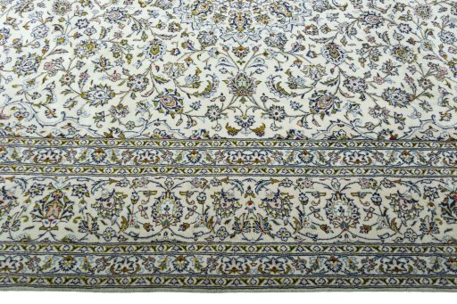 Corner detail of 2000s Kashan rug showing border pattern and Wool pile