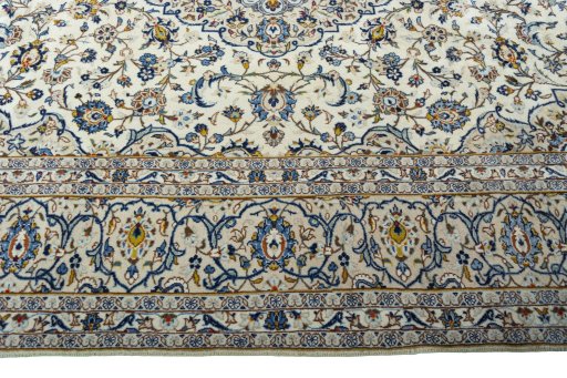 Corner detail of 2000s Kashan rug showing border pattern and Wool pile