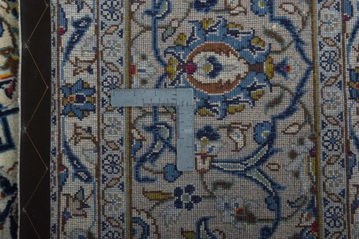 Backside of handmade 2000s Kashan rug showing knot structure and weave density