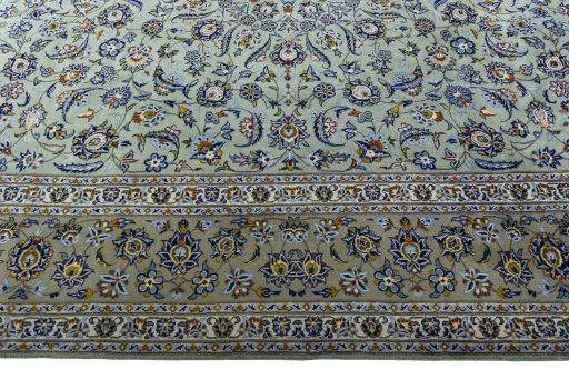 Corner detail of 2000s Kashan rug showing border pattern and Wool pile