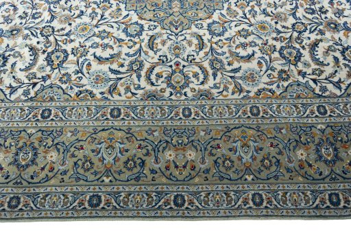 Corner detail of 2000s Kashan rug showing border pattern and Wool pile