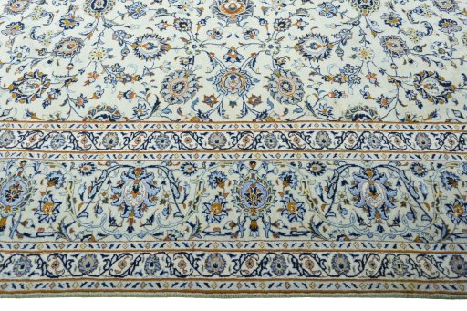 Corner detail of 2000s Kashan rug showing border pattern and Wool pile