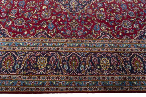Corner detail of 2000s Kashan rug showing border pattern and Wool pile