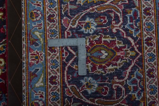 Backside of handmade 2000s Kashan rug showing knot structure and weave density