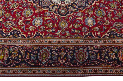 Corner detail of 2000s Kashan rug showing border pattern and Wool pile
