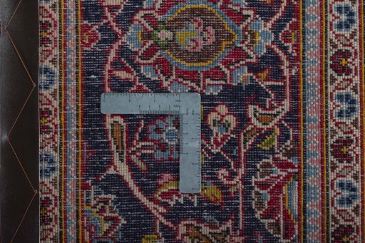 Backside of handmade 2000s Kashan rug showing knot structure and weave density