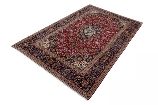 Corner detail of 2000s Kashan rug showing border pattern and Wool pile