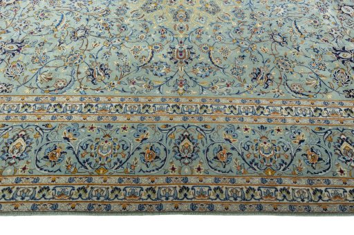 Corner detail of 2000s Kashan rug showing border pattern and Wool pile