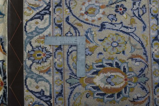 Backside of handmade 2000s Kashan rug showing knot structure and weave density