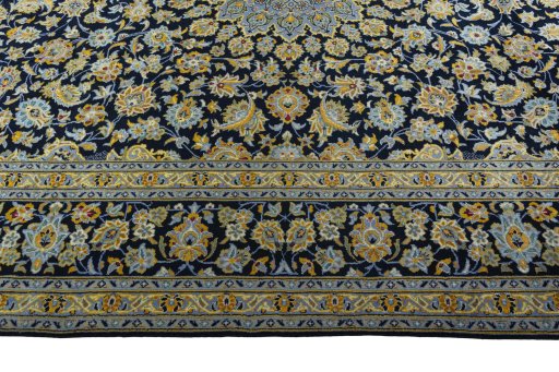Corner detail of 2000s Kashan rug showing border pattern and Wool pile