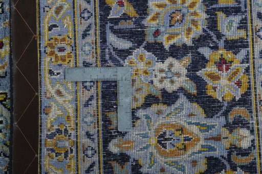 Backside of handmade 2000s Kashan rug showing knot structure and weave density