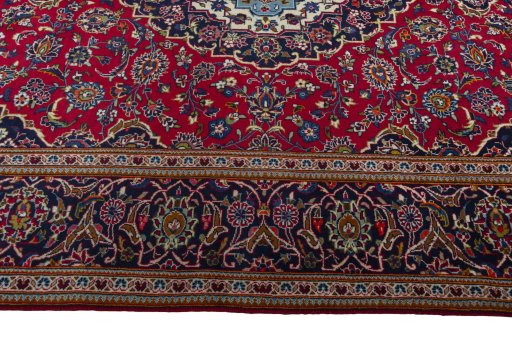 Corner detail of 2000s Kashan rug showing border pattern and Wool pile