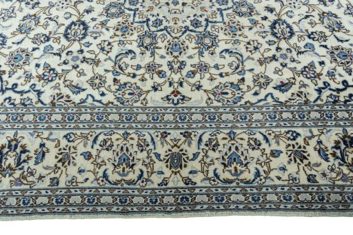 Corner detail of 2000s Kashan rug showing border pattern and Wool pile