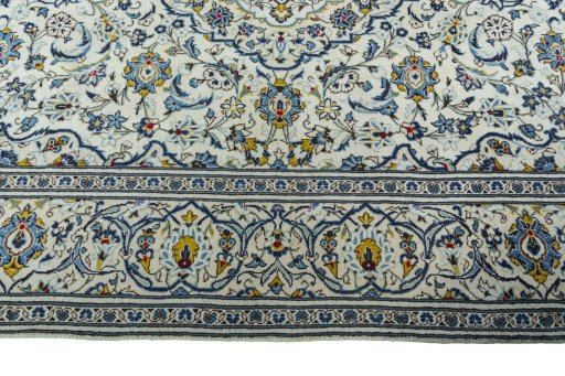 Corner detail of 2000s Kashan rug showing border pattern and Wool pile