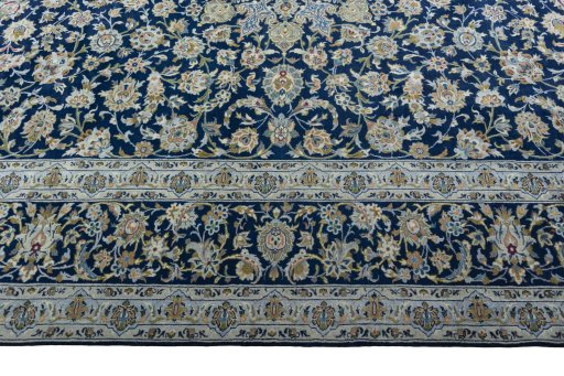 Corner detail of 2000s Kashan rug showing border pattern and Wool pile