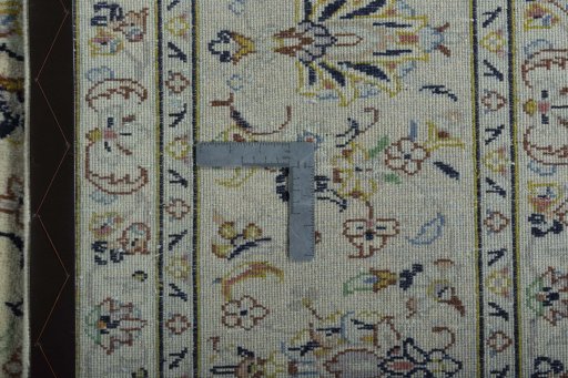 Backside of handmade New Kashan rug showing knot structure and weave density