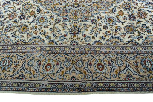 Corner detail of 2000s Kashan rug showing border pattern and Wool pile
