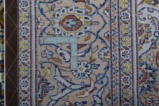 Backside of handmade 2000s Kashan rug showing knot structure and weave density