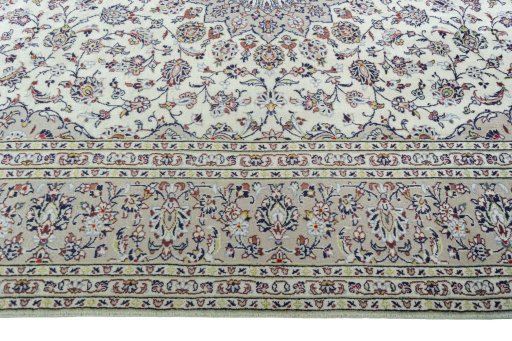 Corner detail of 2000s Kashan rug showing border pattern and Wool pile