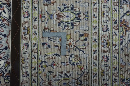 Backside of handmade 2000s Kashan rug showing knot structure and weave density