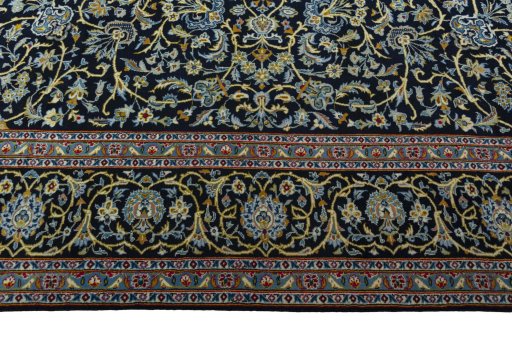 Corner detail of 2000s Kashan rug showing border pattern and Wool pile