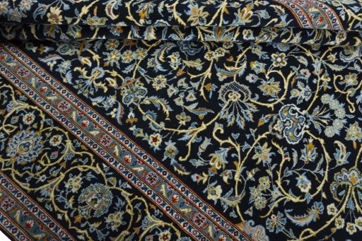 Close-up detail of 2000s Kashan rug from Iran / Persia showing Wool weave
