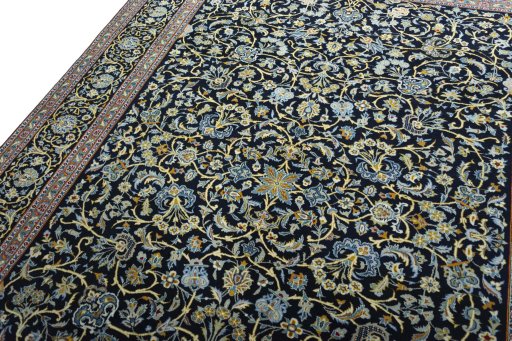 Backside of handmade 2000s Kashan rug showing knot structure and weave density