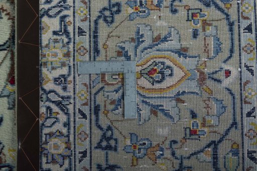 Backside of handmade 1970s Kashan rug showing knot structure and weave density