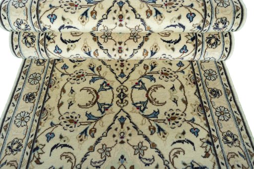 Corner detail of 2000s Kashan rug showing border pattern and Wool pile