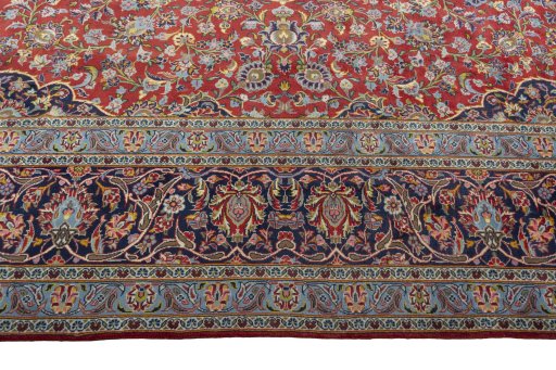 Corner detail of 2000s Kashan rug showing border pattern and Cork pile