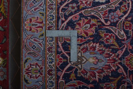 Backside of handmade 2000s Kashan rug showing knot structure and weave density