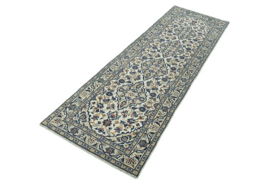 Corner detail of 2000s Kashan rug showing border pattern and Wool pile