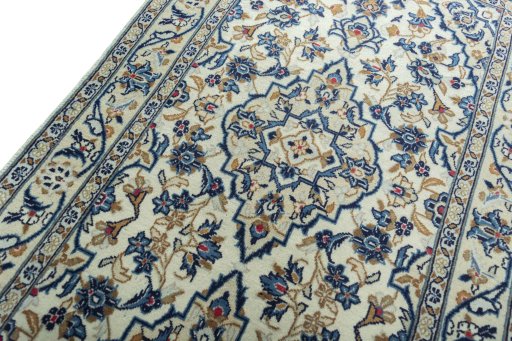 Backside of handmade 2000s Kashan rug showing knot structure and weave density
