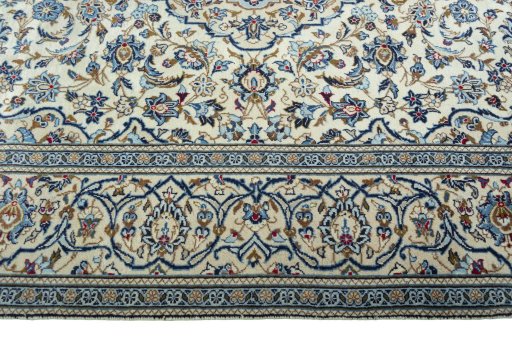 Corner detail of 2000s Kashan rug showing border pattern and Wool pile