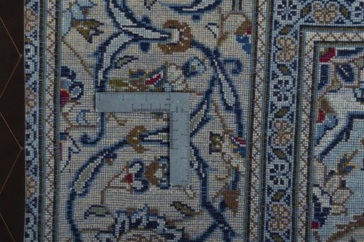 Backside of handmade 2000s Kashan rug showing knot structure and weave density