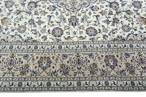 Corner detail of 2000s Kashan rug showing border pattern and Wool pile