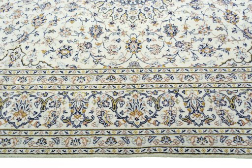 Corner detail of 2000s Kashan rug showing border pattern and Wool pile