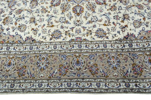Corner detail of 2000s Kashan rug showing border pattern and Wool pile