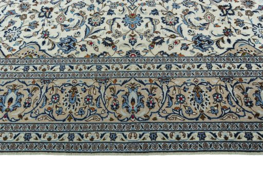 Corner detail of 2000s Kashan rug showing border pattern and Wool pile